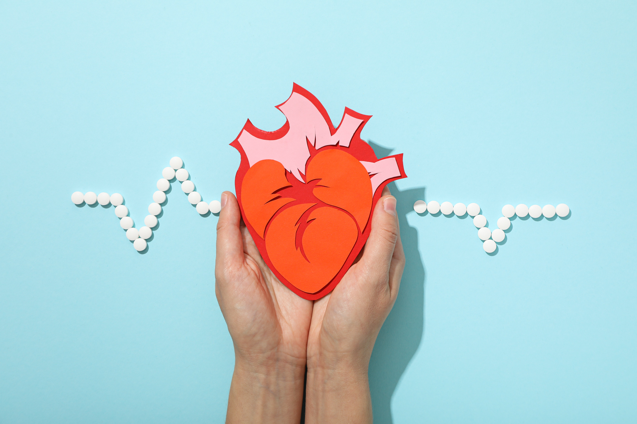Heart with a cardiogram on a light background.